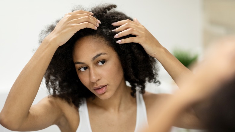 Woman checking scalp 