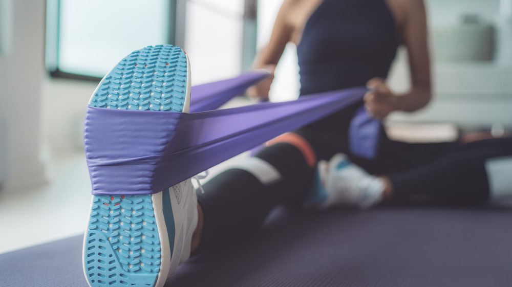 Woman on yoga mat stretching