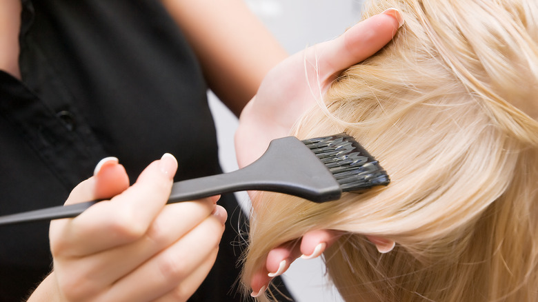 Colorist bleaching hair
