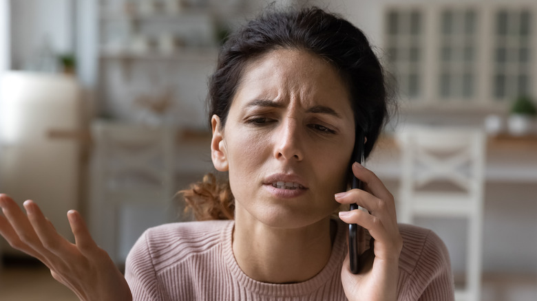 confused woman on cell phone