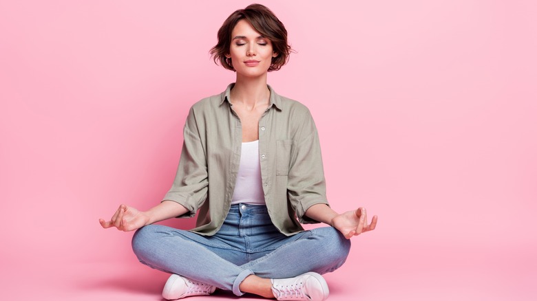 Girl meditating in green shirt