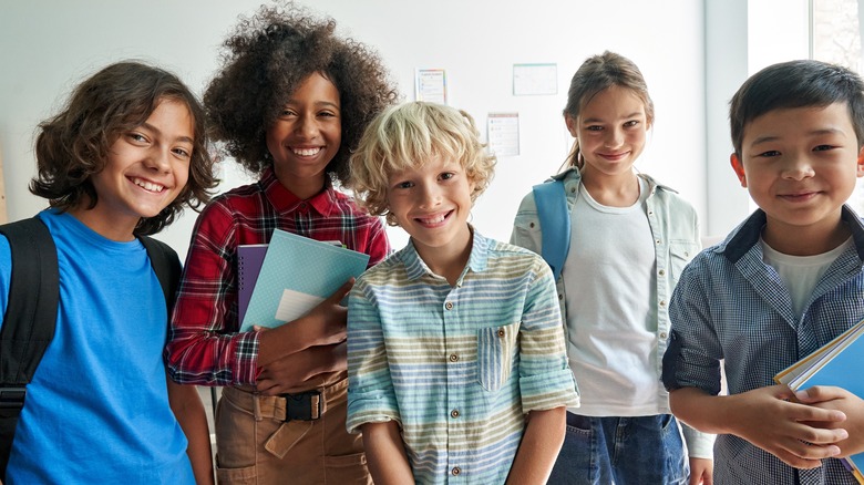 Multiethnic students holding school book