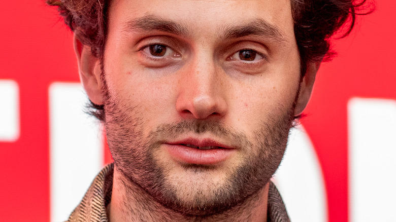 Penn Badgley with slight smile