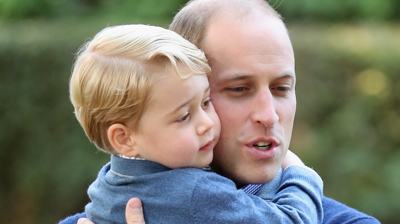 Prince William holding son Prince George