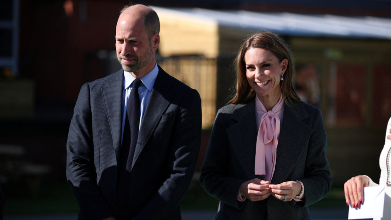 Prince William and Princess Catherine standing next to each other during royal engagement