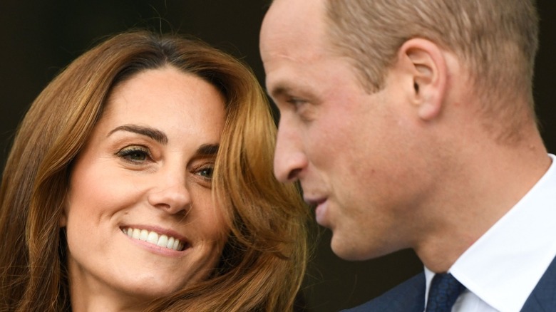 Prince and Princess of Wales smiling at each other