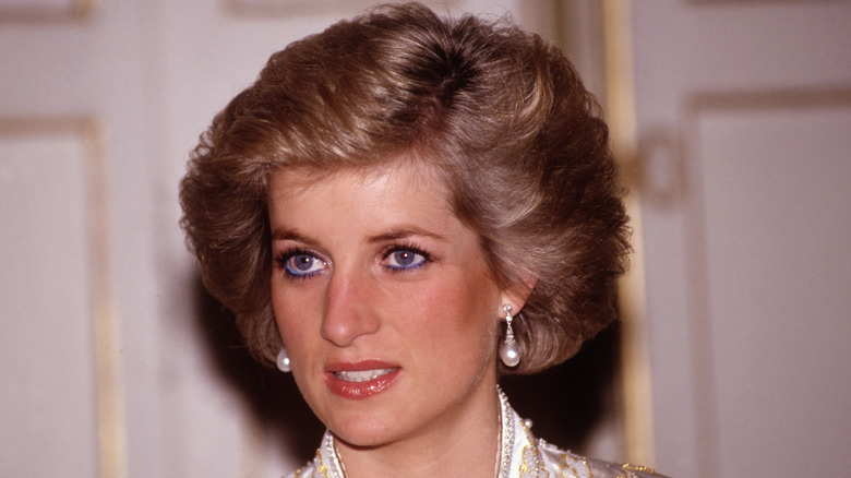 Princess Diana looks off to the side