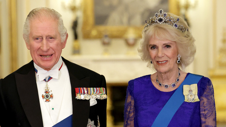 King Charles and Queen Camilla smiling 
