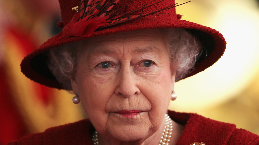 Queen Elizabeth II in a red hat