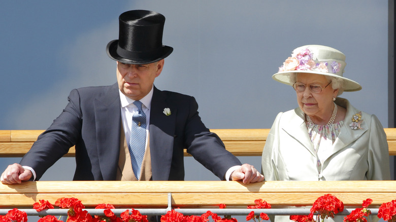 Prince Andrew and Queen Elizabeth looking stern