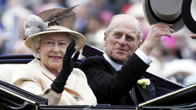 Queen Elizabeth II and Prince Philip waving from their carriage