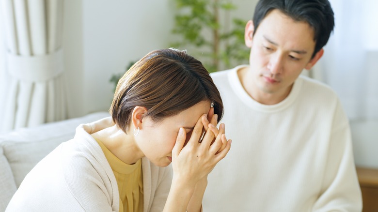 distressed woman comforted by partner