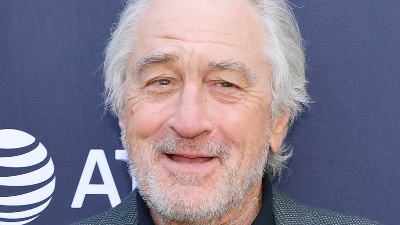 Robert De Niro smiles at an event