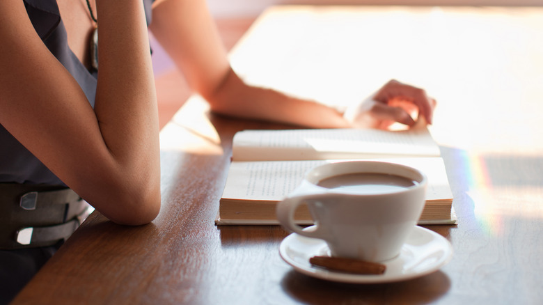 book and coffee on table