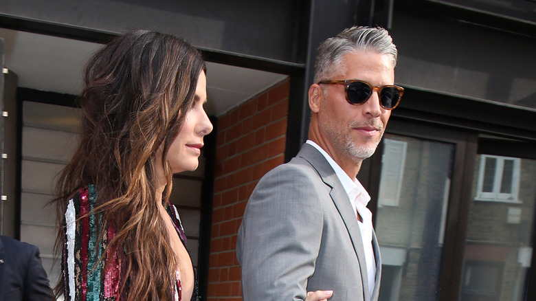 Sandra Bullock and Bryan Randall walking together to an event