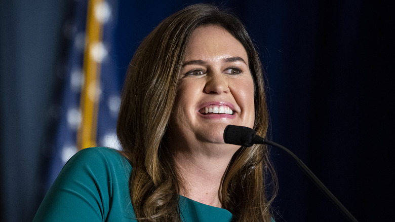 Sarah Huckabee Sanders speaking in microphone