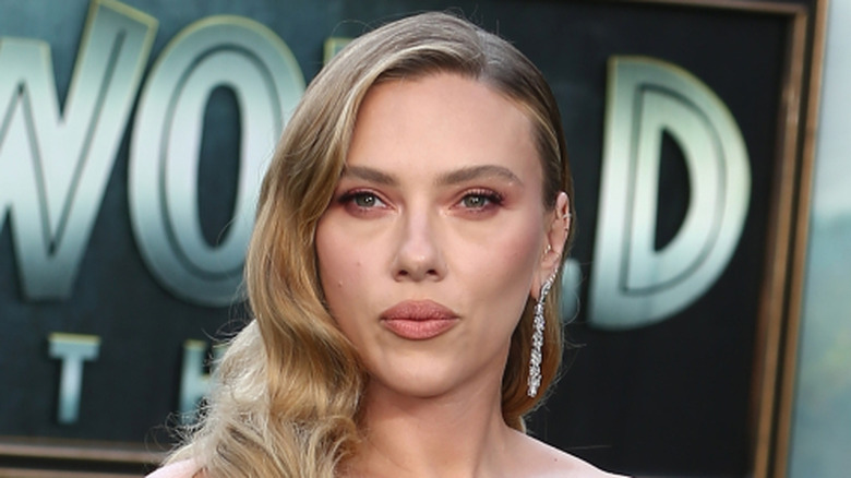 Scarlett Johansson in front of 'Jurassic World Rebirth' backdrop