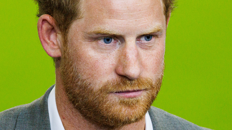 Prince Harry, looking down pensively