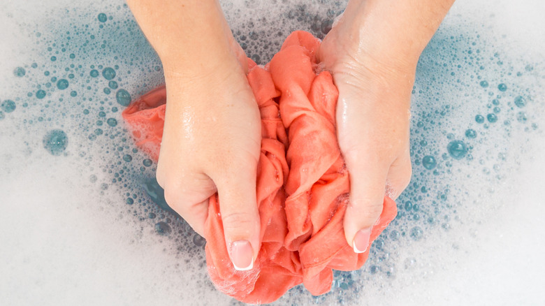 Washing clothes by hand