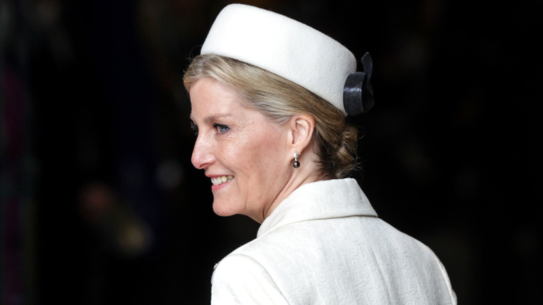 Sophie, Duchess of Edinburgh looking over shoulder in white suit