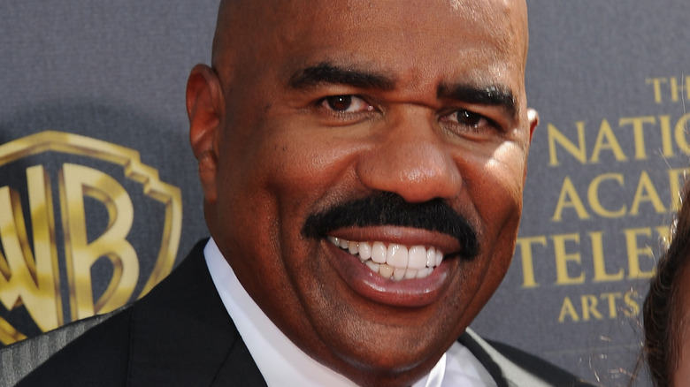 Steve Harvey smiling at a public event