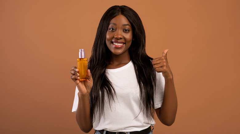 woman holding almond oil