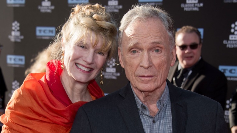 Martha Rogers and Dick Cavett pose at a red carpet event.