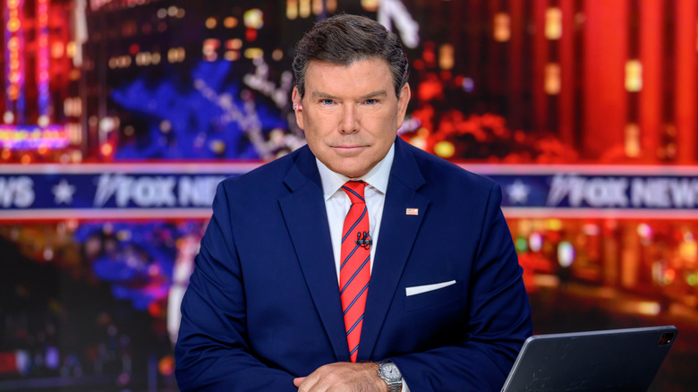 Bret Baier sits at a news desk