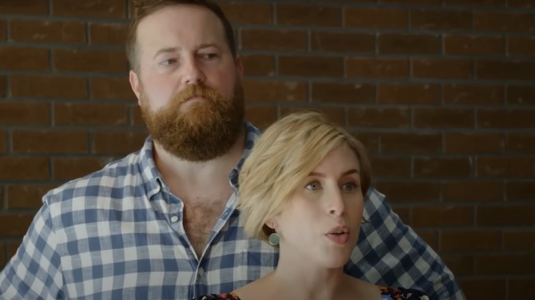 Ben Napier standing behind Erin Napier in an episode of 'Home Town'