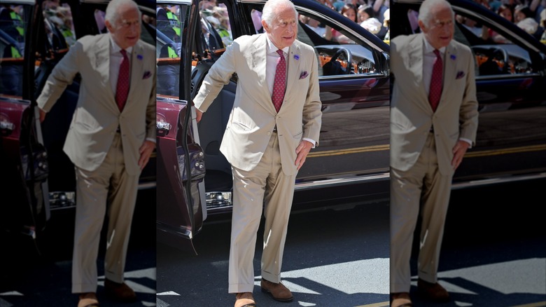 King Charles III exiting a car.