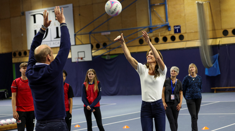 Prince William and Princess Catherine playing netball.