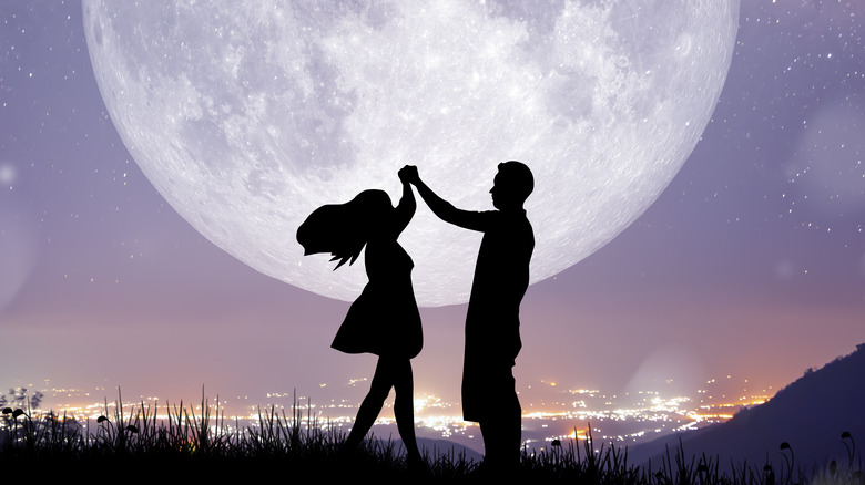 Couple dancing during full moon 