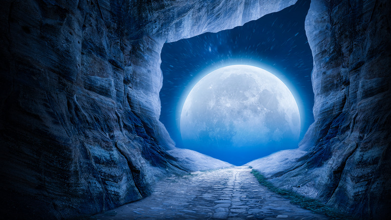 A full moon seen from a cave. 