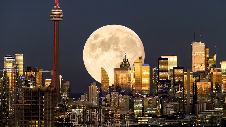 A full moon over a city. 
