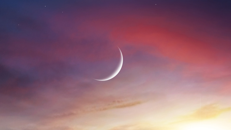 New moon crescent during sunset 