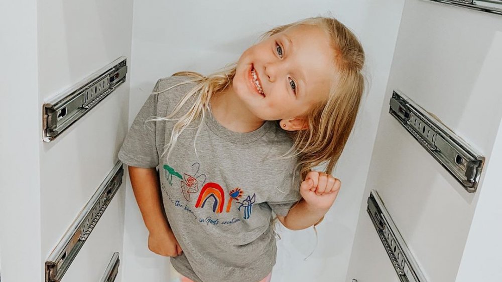 Olivia Busby posing in a file cabinet