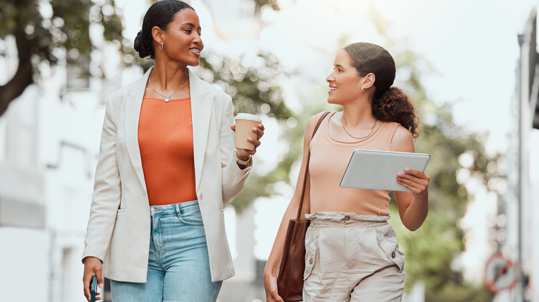 friends chatting while walking outdoors