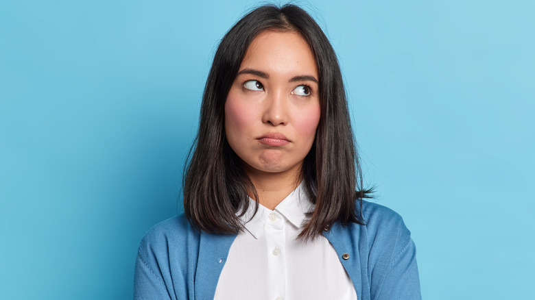 Woman rolling her eyes