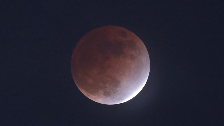 Close up of a full moon half red