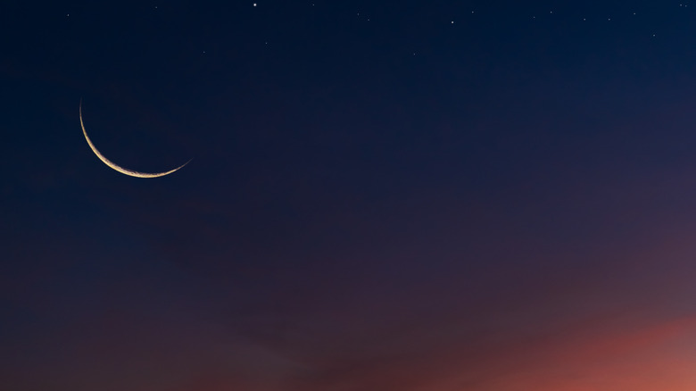 sliver of a moon in a night sky