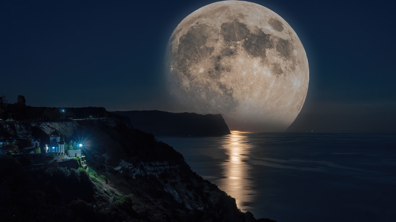 A large full moon over water. 