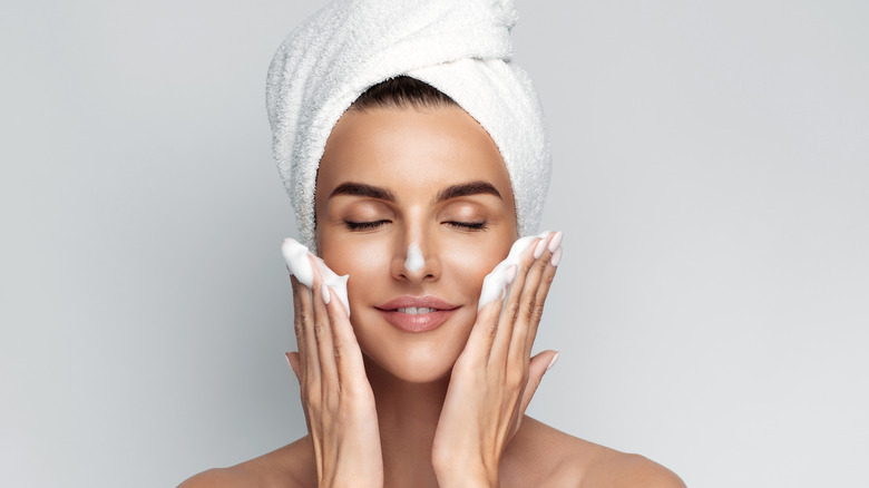 A woman washing her face. 