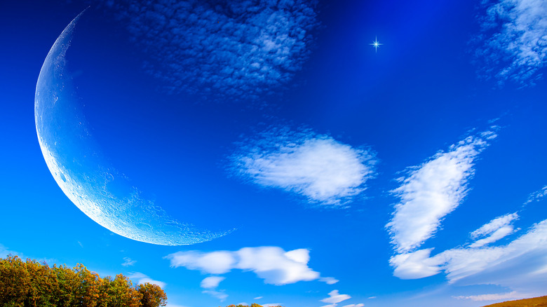 A moon and clouds in the sky. 