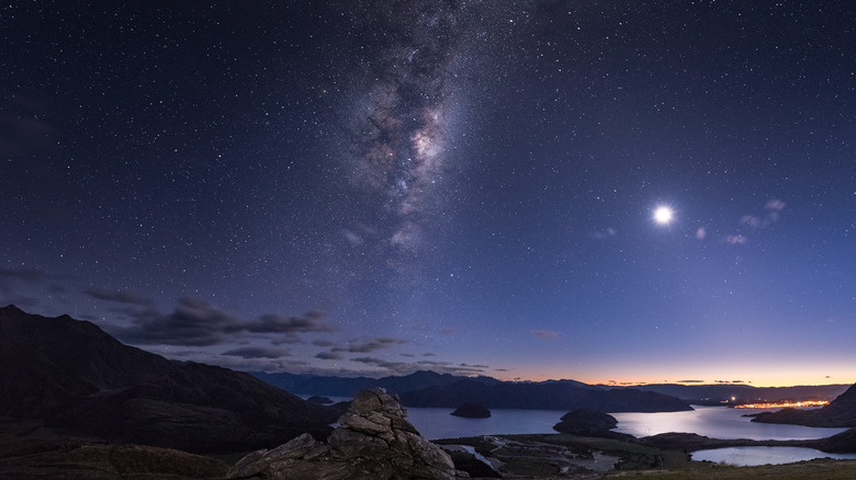 Moon and galaxy above ocean