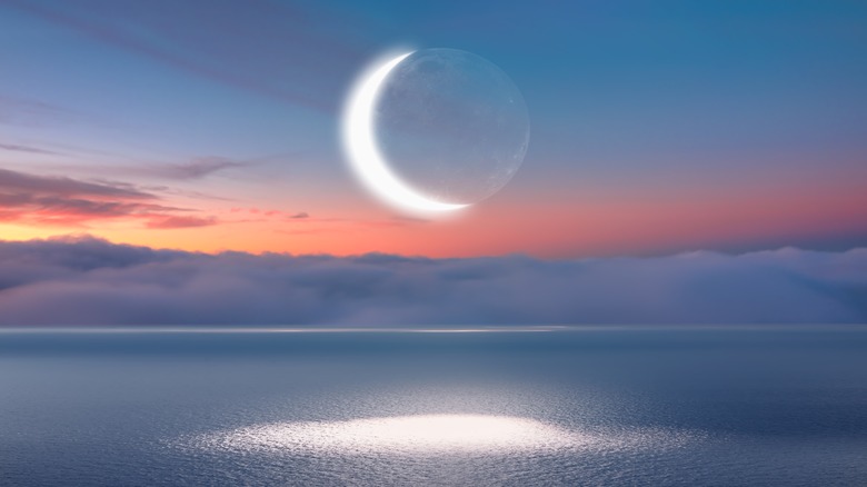 new moon over water