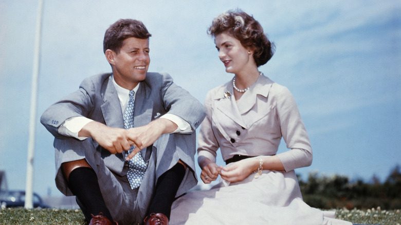 John F. and Jackie Kennedy sitting together in the sunshine 