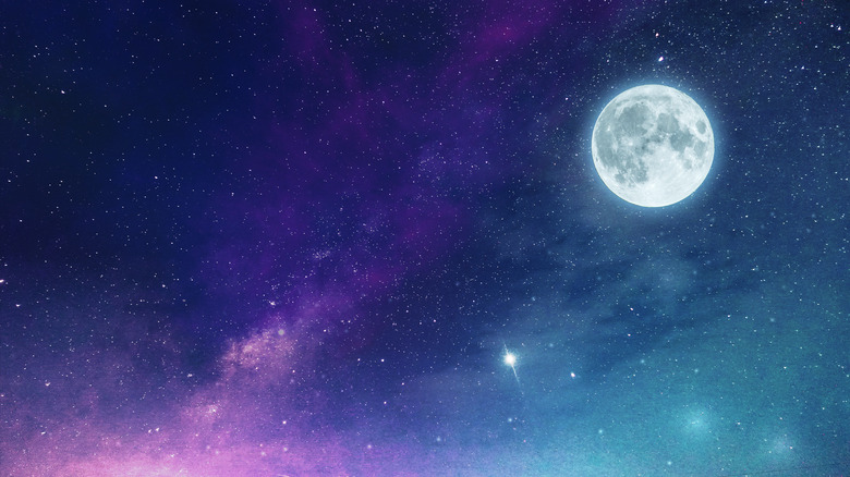 Full moon in a cosmic purple and blue starry sky 