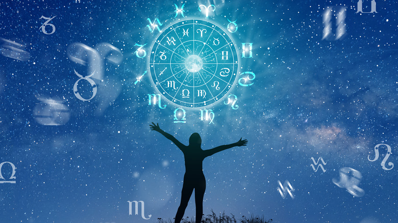person in front of zodiac wheel