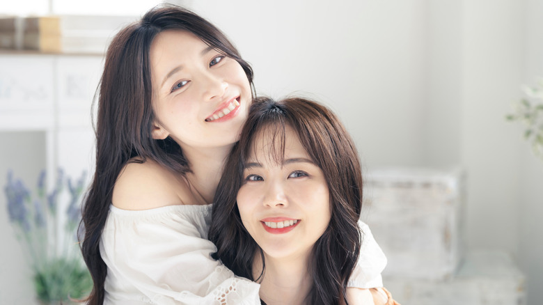 Two women pose for a photo. 