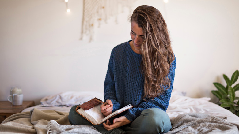 Woman making goals in her journal